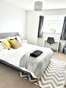 a bedroom with a large white bed with a rug at Eden Hotel - Beach Apartments & Suites in Saint Helier Jersey