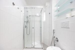 a white bathroom with a shower and a toilet at THE GRAND VIEW Lux Vatican Suite in Rome +41 photos