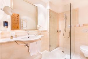 a bathroom with a sink and a shower at Chasa Castello relax & spa in Samnaun