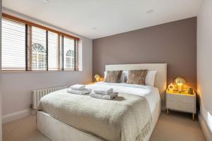 a bedroom with a large bed with towels on it at Prime Covent Garden gem with Air-Con in London