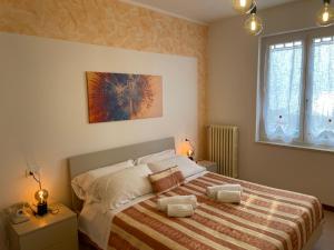 a bedroom with a large bed and two windows at Hotel Panoramica in Bardolino +109 photos