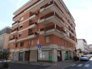 a tall brick building on a city street at Casa Carducci in Grado