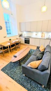 a living room with a couch and a table at Luxury One Bedroom Apartment in the City Centre in Edinburgh
