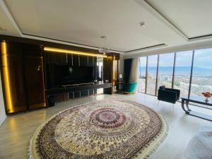 a living room with a large rug on the floor at BALAND HOTEL DUSHANBE in Dushanbe