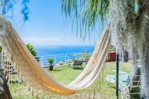 a hammock with the view of the ocean at BioFuncho in Funchal