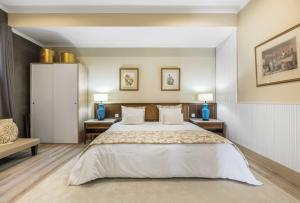 a bedroom with a large white bed and two tables at BioFuncho in Funchal