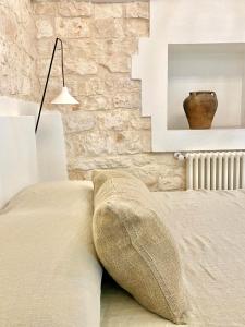 A bed or beds in a room at Trullo Falco