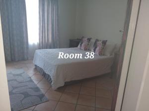 a bedroom with a bed with a room sign on it at 999 Pretorius street in Pretoria