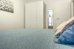 a bedroom with a large bed with blue sheets at La Culla di Milano in Milan