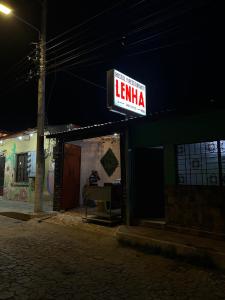 a sign that reads lenka on a building at night at Hostal Lenha in Concepción de Ataco
