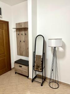 a dressing room with a mirror and a lamp at Apartman Marko in Risan