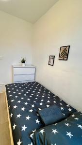 a bedroom with a bed with stars on it at Rooms in Warsaw in Warsaw