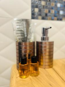 two bottles of essential oils sitting on a wooden table at Jacuzzi Glass-House Central Station in Krakow