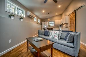 a living room with a couch and a table at Pisgah Hillside Haven in Pisgah Forest