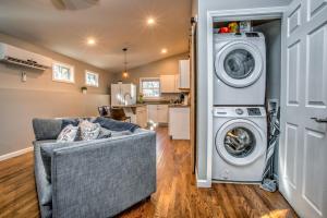 a living room with a washing machine and a couch at Pisgah Hillside Haven in Pisgah Forest