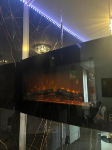 a fireplace in a living room with a fire place at Jacuzzi Glass-House Central Station in Krakow