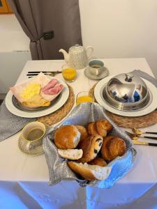 a table with a tray of bread and plates of food at La Glycine in Chamoux-sur-Gelon