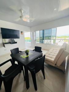 a living room with a table and a couch at TORRES DEL MESÓN LUXURY APARTMENTS Doradal in Doradal