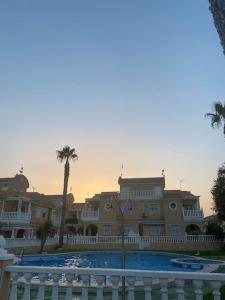 a large house with a pool in front of it at Sol Beach, Cabo Roig in Orihuela Costa