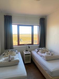Voodi või voodid majutusasutuse Guesthouse Nypugardar toas