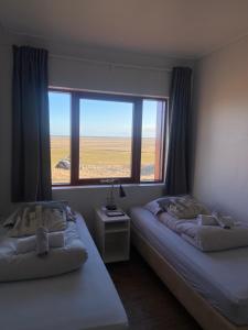 Voodi või voodid majutusasutuse Guesthouse Nypugardar toas