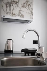a kitchen sink with a faucet and a toaster at Horizont Apart-Hotel & City Center Balcony View in Shkodër +57 photos