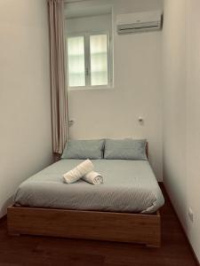 a bed with a wooden frame in a bedroom at Voyager in Cagliari