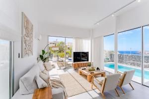 a living room with a view of the ocean at Villa Larisa - private heated pool, chill out and BBQ in Callao Salvaje