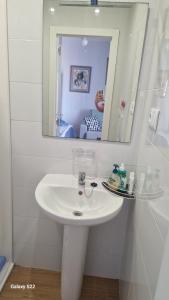 a bathroom with a white sink and a mirror at Beach Life Carabassi Beach Gran Alacant in Gran Alacant