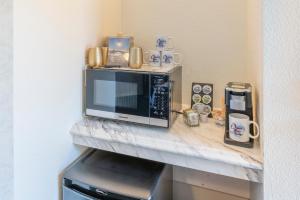 a counter with a microwave on top of a table at Ocean View Lodge in Fort Bragg