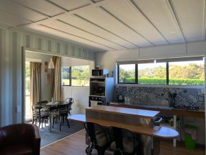 a kitchen and dining room with a table and chairs at Alpine Manuka View Cabin in Kaikoura