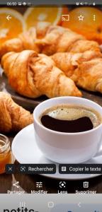 a picture of a cup of coffee and croissants at Chambres d'hôtes Drome in Chatuzange-le-Goubet