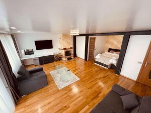 a large living room with a couch and a bed at Casa YDA in Horezu
