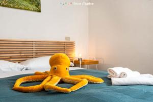 a stuffed octopus is laying on a bed at La Tana del Polpo in Monterosso al Mare