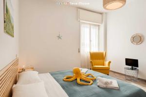 a room with a bed with a large yellow object on it at La Tana del Polpo in Monterosso al Mare