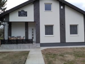 a house with a black and white facade at Apartman Dve lipe in Palić