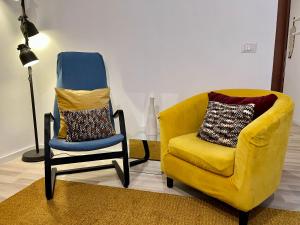 a living room with two chairs and a lamp at Charming Navona in Rome