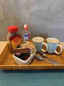 a tray with cups and utensils on a table at Loft Vista dos Arcos in Rio de Janeiro