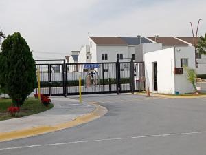 a black fence in front of a street with houses at AIRPORT APARTMENT MONTERREY 628 in Monterrey