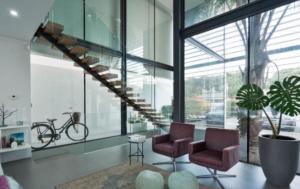 a living room with two chairs and a spiral staircase at Luxurious Villa Vilamoura in Vilamoura