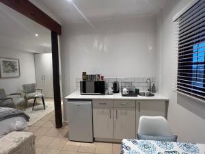 a kitchen with a sink and a microwave at Jefa Heights in Cape Town