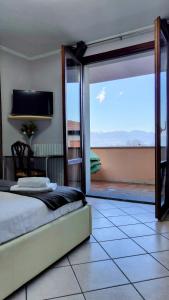 a bedroom with a bed and a sliding glass door at B&B Madonna della Neve in Stresa