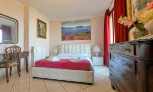 a bedroom with a bed and a dresser in it at B&B Madonna della Neve in Stresa