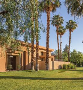 a house with palm trees in front of it at WorldMark Palm Springs - Plaza Resort and Spa in Palm Springs
