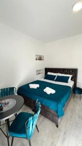 a bedroom with a bed and a table and chairs at STR Apartment in Tivat