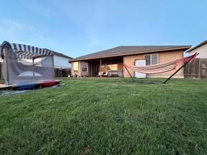 a house with a tent and a hammock in a yard at Sunset Zen Space in Killeen