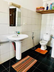 a bathroom with a sink and a toilet at Villa baobab in Ramena