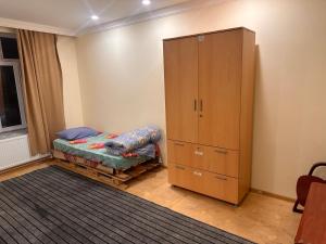 a bedroom with a bed and a cabinet at Sovet Hostel in Baku