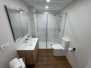a bathroom with a shower and a sink and a toilet at Paraíso frente al mar , espectacular apartamento in El Vendrell +10 photos
