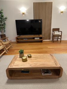 a living room with a large television and a coffee table at BaySun Apartment & SPA - Bayline in Armação de Pêra